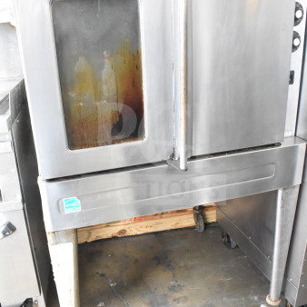 Blodgett full-size convection oven with view-through and solid doors, thermostatic controls, on metal legs and casters. Signs of wear.