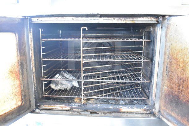 Blodgett commercial full-size convection oven with view-through solid door, thermostatic controls, metal legs, and casters.