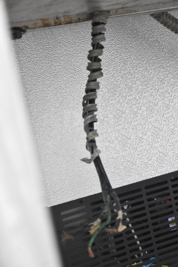 Blodgett commercial oven wiring detail, showing insulated cables. Auction features full-size convection oven with metal legs and casters.