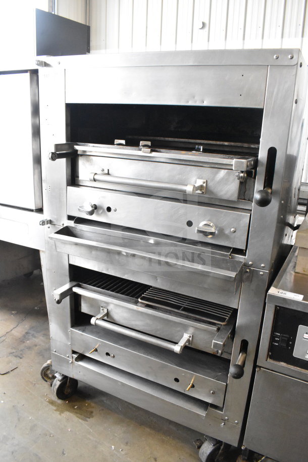 Commercial gas-powered upright 2-deck broiler on casters, industrial-grade stainless steel, dual handles, visible control knobs.