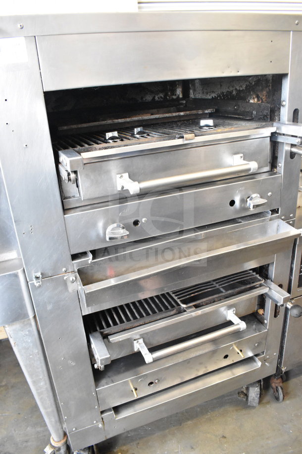 Commercial gas-powered upright 2 deck broiler on casters, stainless steel, used condition, showing two grilling decks.