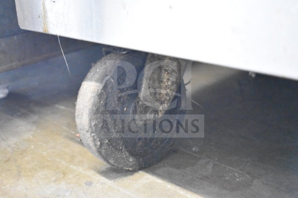 Southbend commercial gas griddle with convection oven, on heavy-duty casters, showing one caster in used condition.
