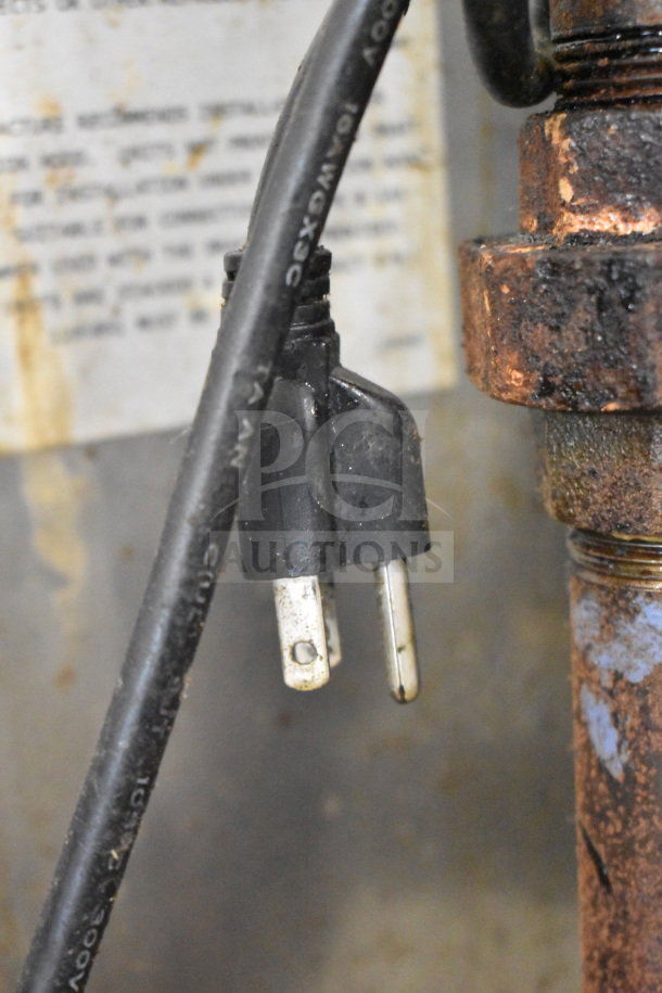 Close-up of power cord and plug on a Southbend commercial gas-powered flat top griddle with convection oven. Rust visible.