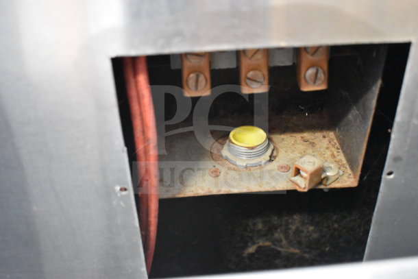 Garland commercial flat top griddle interior view, showing wiring and connections. Signs of use and rust are visible.