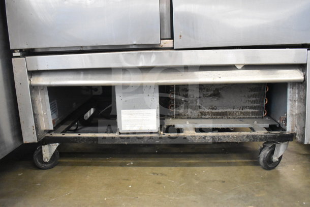 2018 True T-35-HC commercial reach-in cooler on casters, dual doors, 115V, visible wear, on commercial casters.