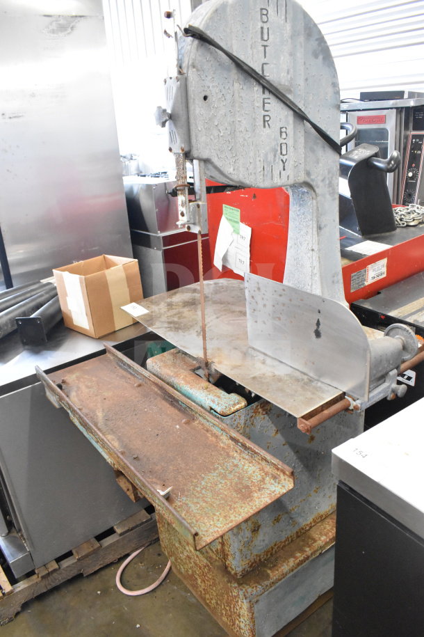 Butcher Boy Commercial Floor Meat Saw, metal construction, visible rust and wear, includes blade, model markings.