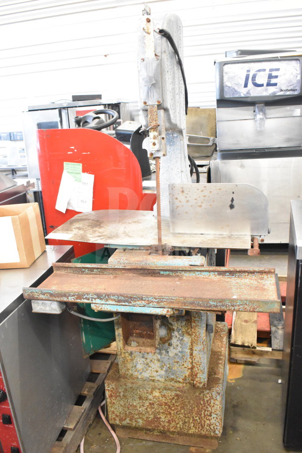 Butcher Boy commercial floor style meat saw in used condition with rust on metal surfaces and visible power cord.
