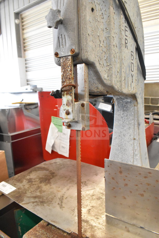 Butcher Boy Commercial Floor Meat Saw, rusted blade and frame, visible wear, industrial setting, Butcher Boy logo.