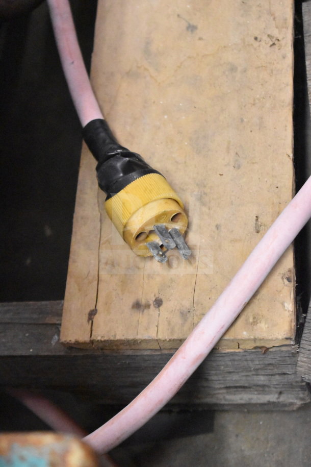 Plug of a Butcher Boy Commercial Floor Style Meat Saw, showing a yellow, three-prong connector and pink cable.