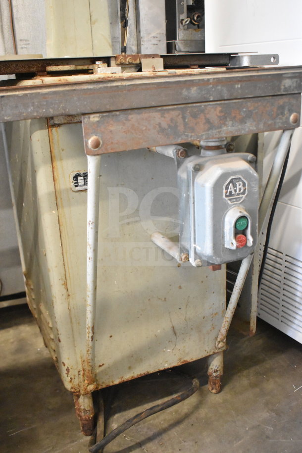 US Berkel commercial floor-style meat saw, 208 volts, 3-phase. Features visible wear and rust on the frame.