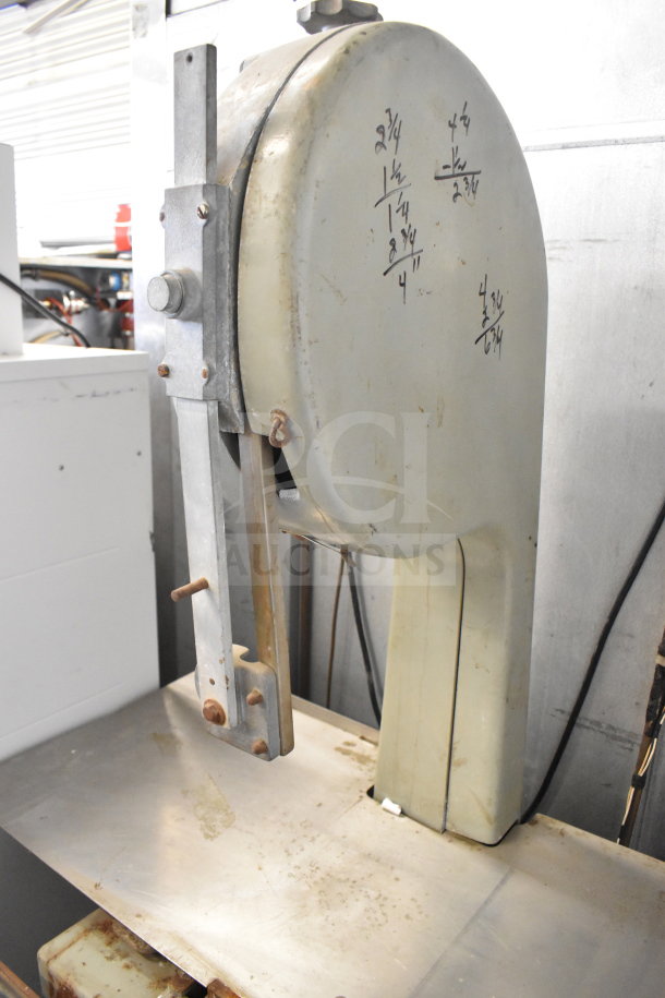 US Berkel commercial floor meat saw, 208 volts, 3 phase. Features metal construction, visible surface wear, handwritten notes.