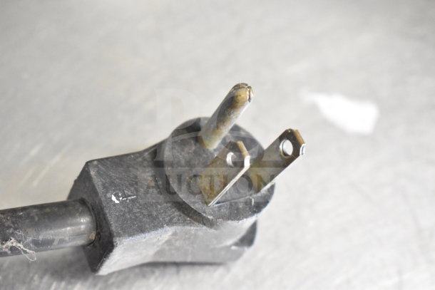 Close-up of a power plug for the Multiplex MA-8-1US Blend In Cup Workstation, showing signs of use.
