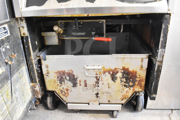 BKI FKM-F electric pressure fryer, 208V, 3-phase, shows signs of wear, rust, and grease. Visible valves and handles.