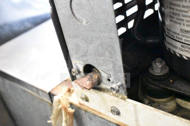 Manitowoc QD1002A ice machine head on MGR SP-800-SS bin, 208-230V, 1 phase. Shows metal housing and bolt details.