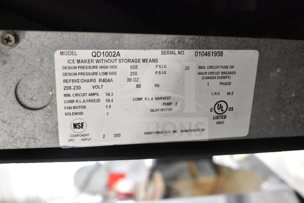 Manitowoc QD1002A ice machine label details voltage, refrigerant, and specs; 208-230 volts, 1 phase, NSF certified.