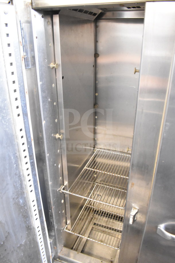 Traulsen RDT 2-24 DUT commercial reach-in refrigerator with stainless steel interior, two doors, two drawers, and wire shelves.
