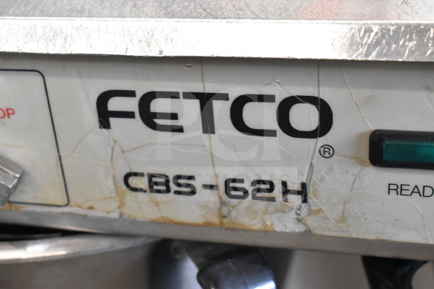 Fetco CBS-62HSt commercial double coffee machine, visible wear, with model label. Features 3 brew baskets, 120V, 1 phase.