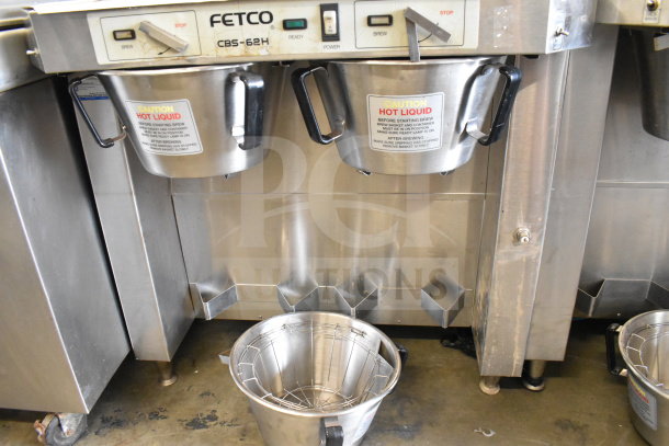 Fetco CBS-62HSt commercial double coffee machine with 3 brew baskets, 120V, 1 Phase. Visible caution labels, stainless finish.