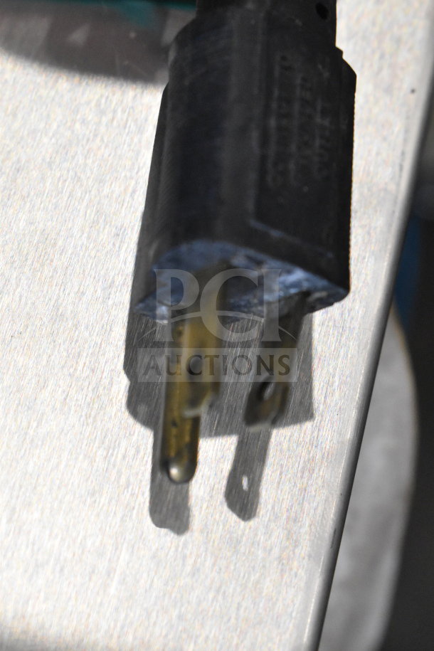 Close-up of a Fetco CBS-62HSt coffee machine plug, showing a standard 120V, 1-phase connection.