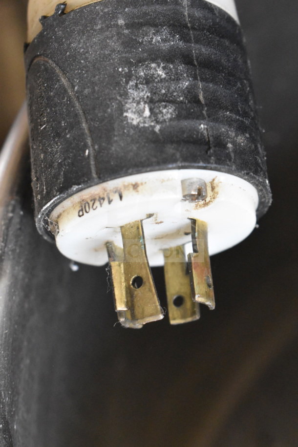 Close-up of a power plug for Attias HS40DA commercial spiral mixer, showing three metal prongs and slight wear.