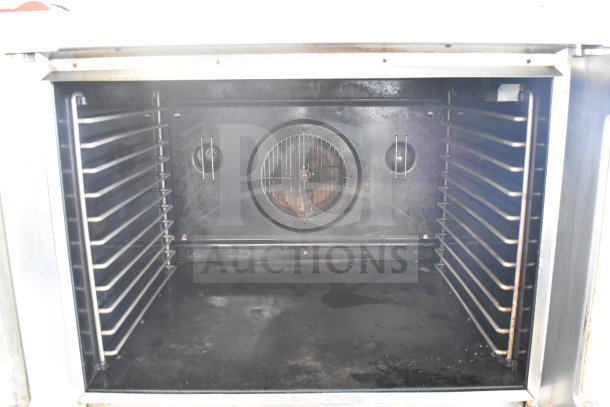 Blodgett commercial gas convection oven interior with racks, view-through doors, and thermostatic controls. On casters.
