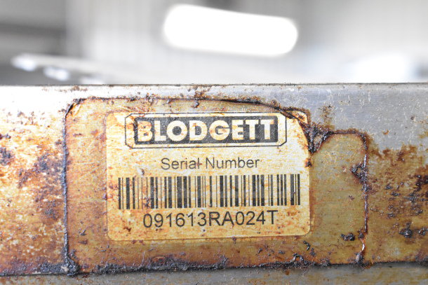 Blodgett commercial convection oven label with serial number 091613RA024T. Rust visible on the metal surface.