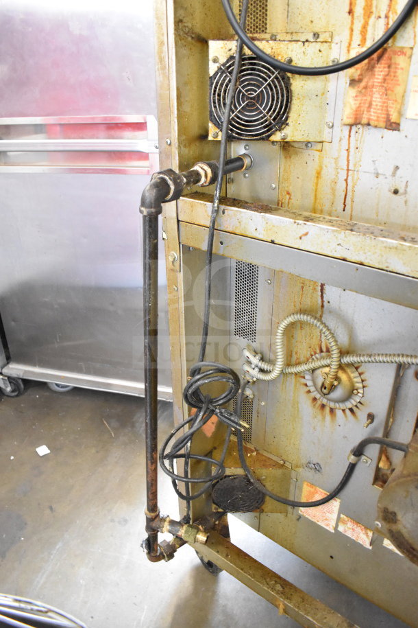 Blodgett commercial gas convection oven rear view with exposed wiring and pipes; visible wear and rust.