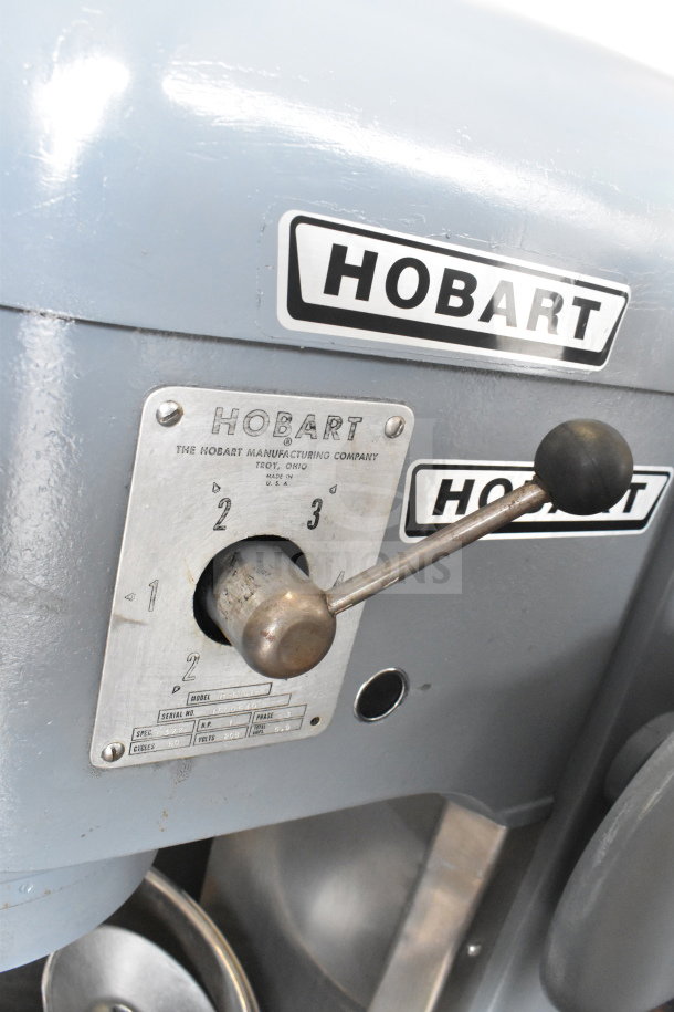 Hobart H-600T commercial dough mixer with label, lever, and attachments. 60-quart capacity, floor style, 208V, 3-phase.