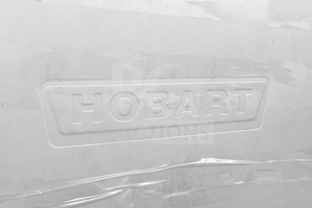 Hobart 6614 commercial meat saw, embossed logo visible. Operates on 200-230 volts, 3 phase, good condition.