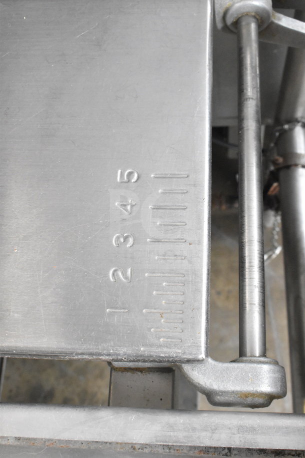 Hobart 6614 Commercial Meat Saw with metal construction, visible numerical markings for adjustments, 200-230V, 3 Phase.