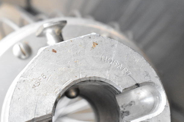 Close-up of metal part inscribed with "NSF8" and "HOBART", likely from a Berkel FMS60 dough mixer. Condition shows wear.