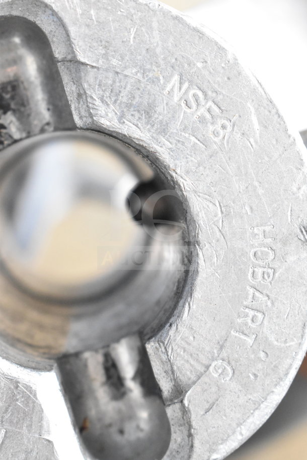 Berkel FMS60 mixer component close-up with NSF8 and HOBART markings. Features sturdy metal construction.