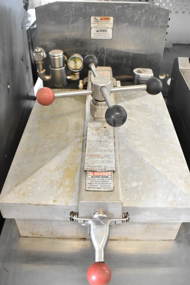Henny Penny 500C commercial electric pressure fryer, floor model, on casters, 208V, 3-phase; control panel and safety labels visible.