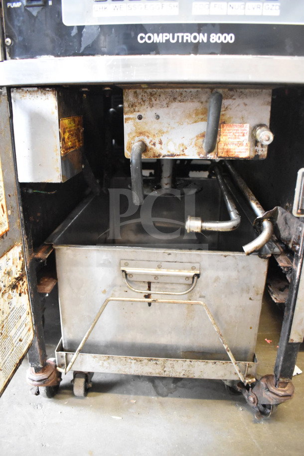 Henny Penny 500C electric pressure fryer, stainless steel, on commercial casters. Features Computron 8000 controls, 208V, 3-phase. Visible wear.