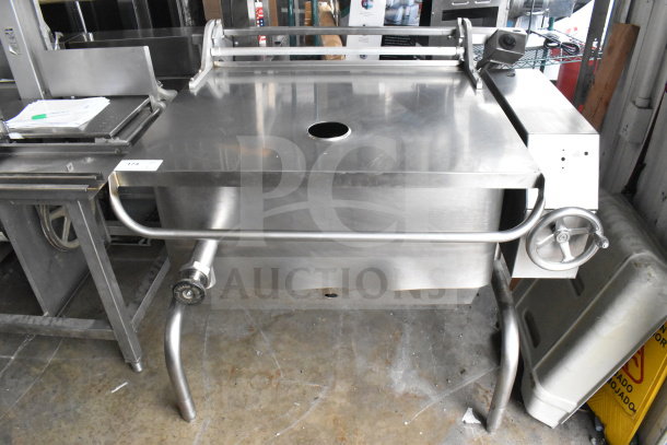 Commercial floor-style manual tilt braising pan, stainless steel, sturdy construction, wheel controls, excellent condition.