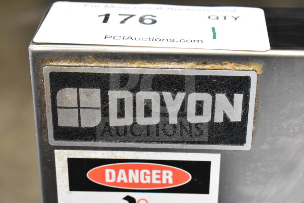 Doyon DL18DP commercial countertop two-stage dough sheeter with visible Doyon logo and safety warning, in used condition.