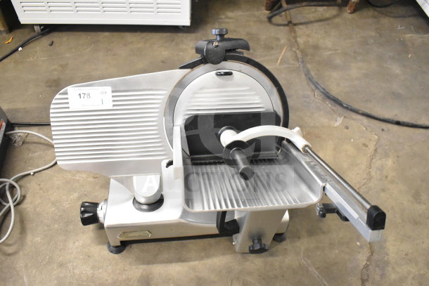 Manconi 300 IX commercial meat slicer with blade sharpener, 120 volts, 1 phase, used condition, metallic finish.