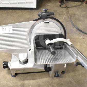 Manconi 300 IX commercial meat slicer with blade sharpener, 120 volts, 1 phase, used condition, metallic finish.