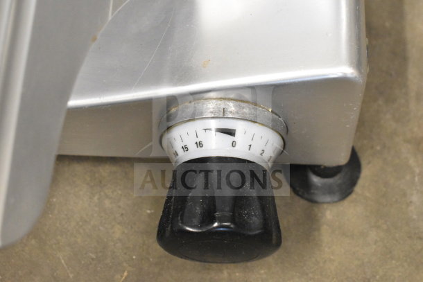 Manconi 300 IX commercial meat slicer detail showing the adjustment knob and stainless steel body in good condition.