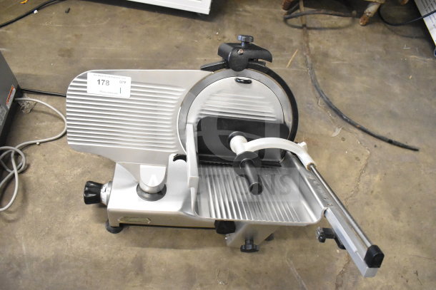Manconi 300 IX commercial meat slicer with blade sharpener, 120V, 1 Phase, in good condition, visible safety and control knobs.