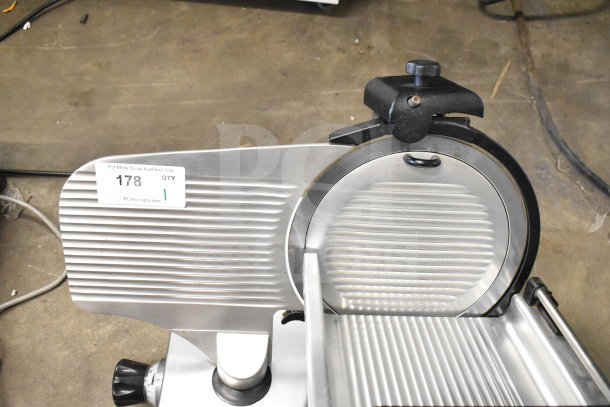 Manconi 300 IX commercial countertop meat slicer with blade sharpener, 120V, 1 phase, excellent condition, auction tag visible.