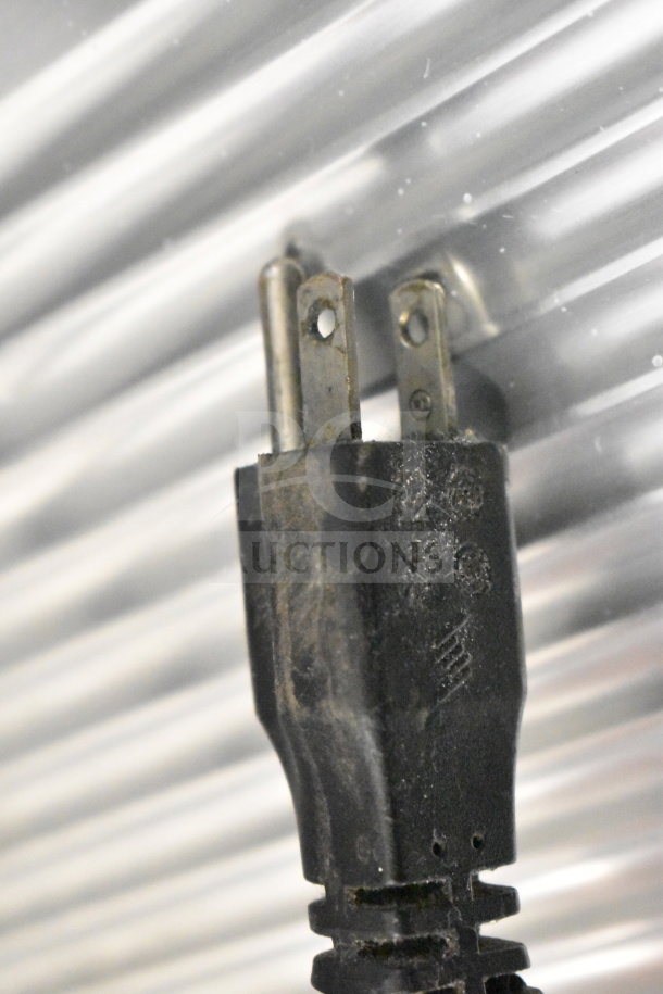 Black power plug for Manconi 300 IX meat slicer, 120 volts, 1 phase. Slight wear visible on plug, indicating use.
