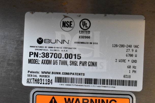 Label on 2018 Bunn AXIOM 0/6 TWIN Coffee Machine, showing model, serial number AXTN031184, voltage, and UL listing.