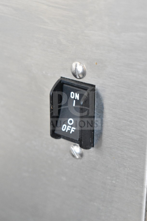 Close-up of an on/off switch on a Bunn AXIOM 0/6 TWIN commercial coffee machine.