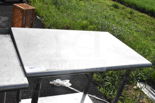 Commercial stainless steel table with under shelf, sturdy condition, marked "181" with auction details card visible.