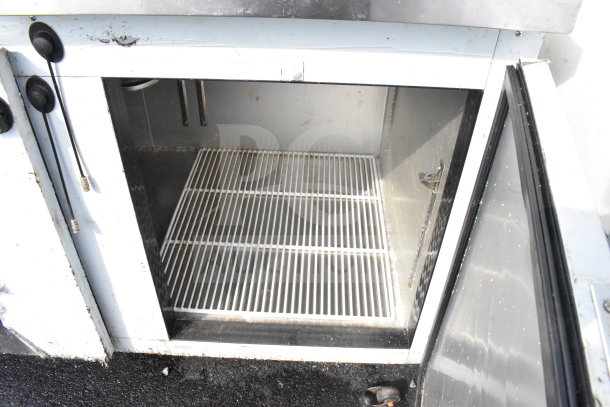 2021 Leader NLB72 3-Door Undercounter Cooler, 115V, 1 Phase, visible grates, minor wear, good condition for auction.