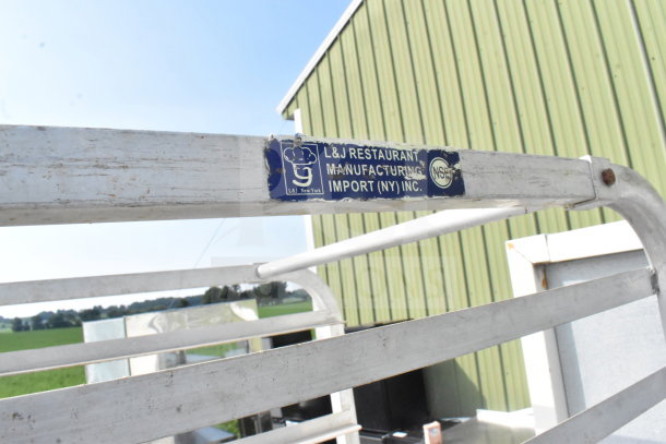 Commercial pan transport rack with casters, metal construction, L&J Restaurant Manufacturing label, NSF certified.