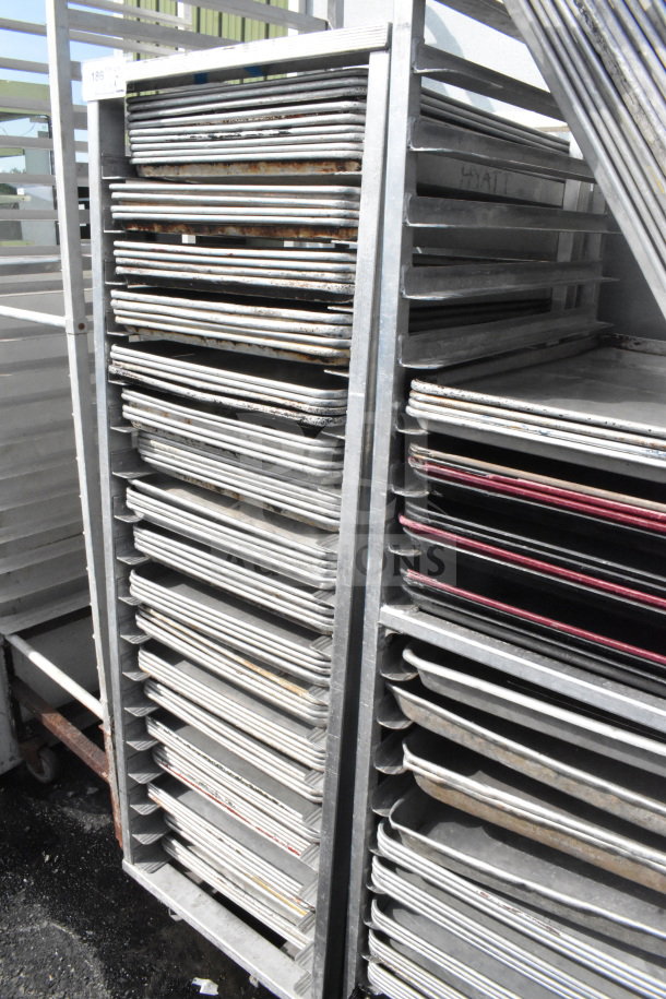 Commercial pan transport rack with 70 baking pans on casters, used condition, suitable for bakery or kitchen use.