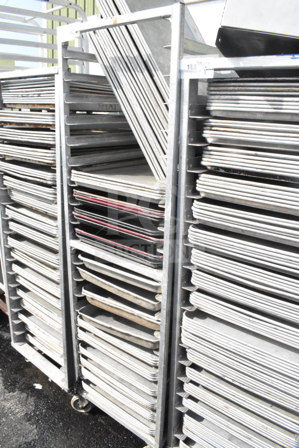 Commercial pan transport rack with 50 baking pans on casters. Sturdy metal construction, ideal for catering and baking needs.