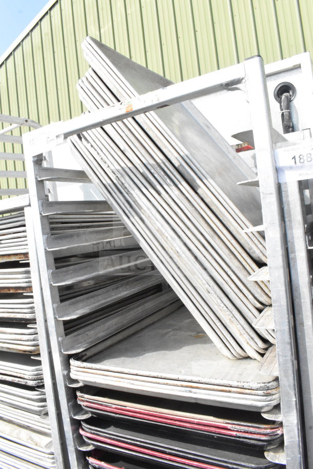 Commercial pan transport rack on casters with 50 baking pans. Used condition. Ideal for bakery or catering use.